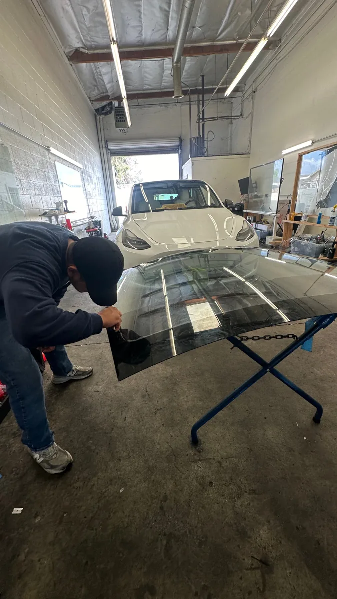 Windshield preparation inside the Superior shop